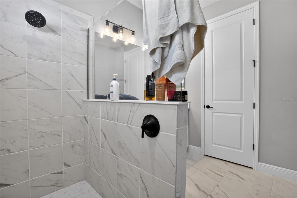 10710 Falling Leaf Court Parrish, FL 34219 - Photo 28 of 50 a bathroom with a shower