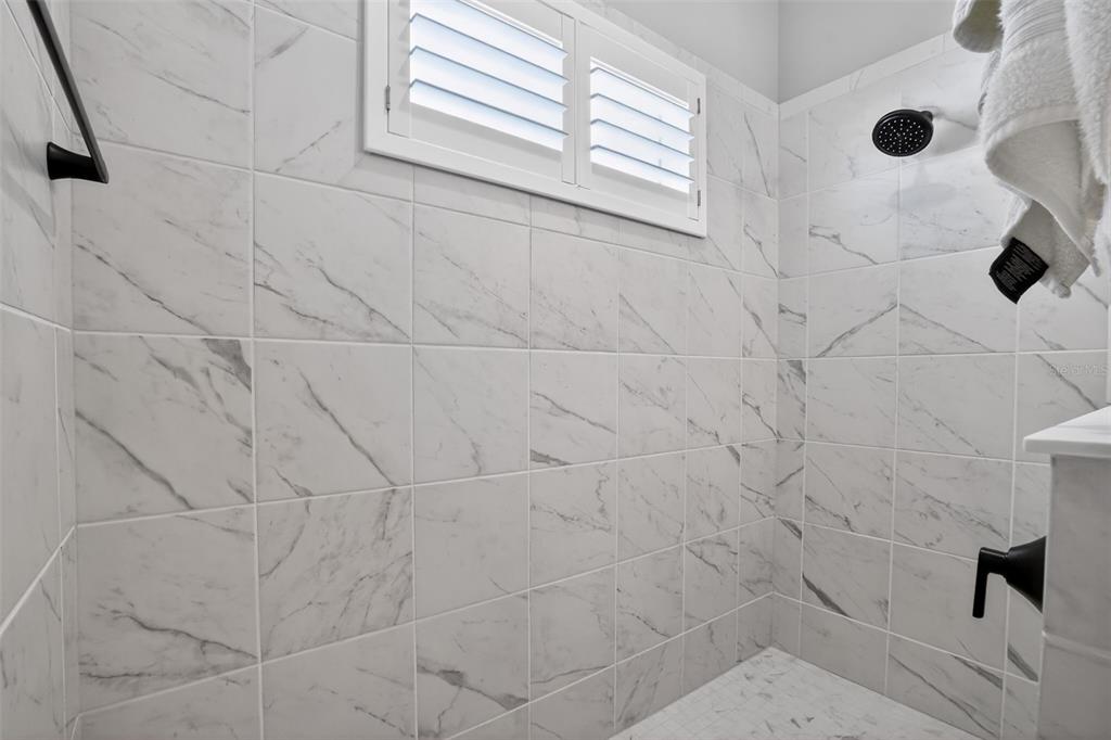 10710 Falling Leaf Court Parrish, FL 34219 - Photo 29 of 50 a bathroom with a window and a shower