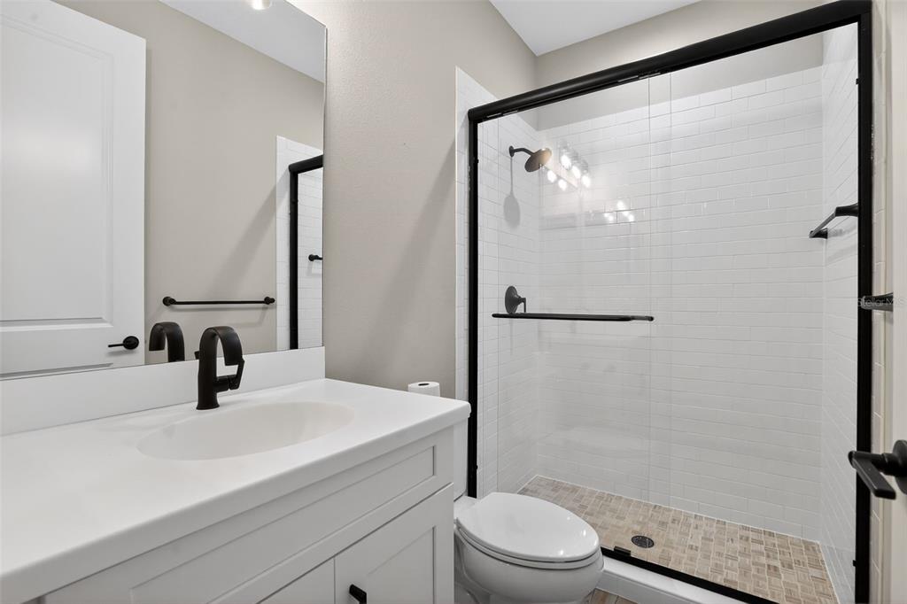 10710 Falling Leaf Court Parrish, FL 34219 - Photo 30 of 50 a bathroom with a sink a toilet and shower