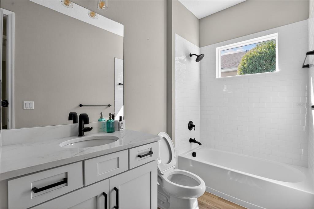 10710 Falling Leaf Court Parrish, FL 34219 - Photo 31 of 50 a bathroom with a granite countertop sink toilet and shower