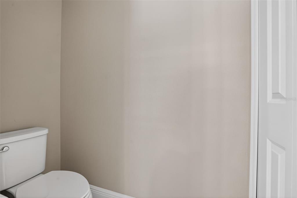 10710 Falling Leaf Court Parrish, FL 34219 - Photo 33 of 50 a white toilet sitting next to a white cabinet