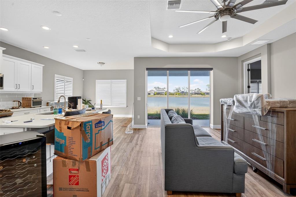 10710 Falling Leaf Court Parrish, FL 34219 - Photo 34 of 50 a large kitchen with stainless steel appliances a stove a sink dishwasher and a dining table with the bookshelf