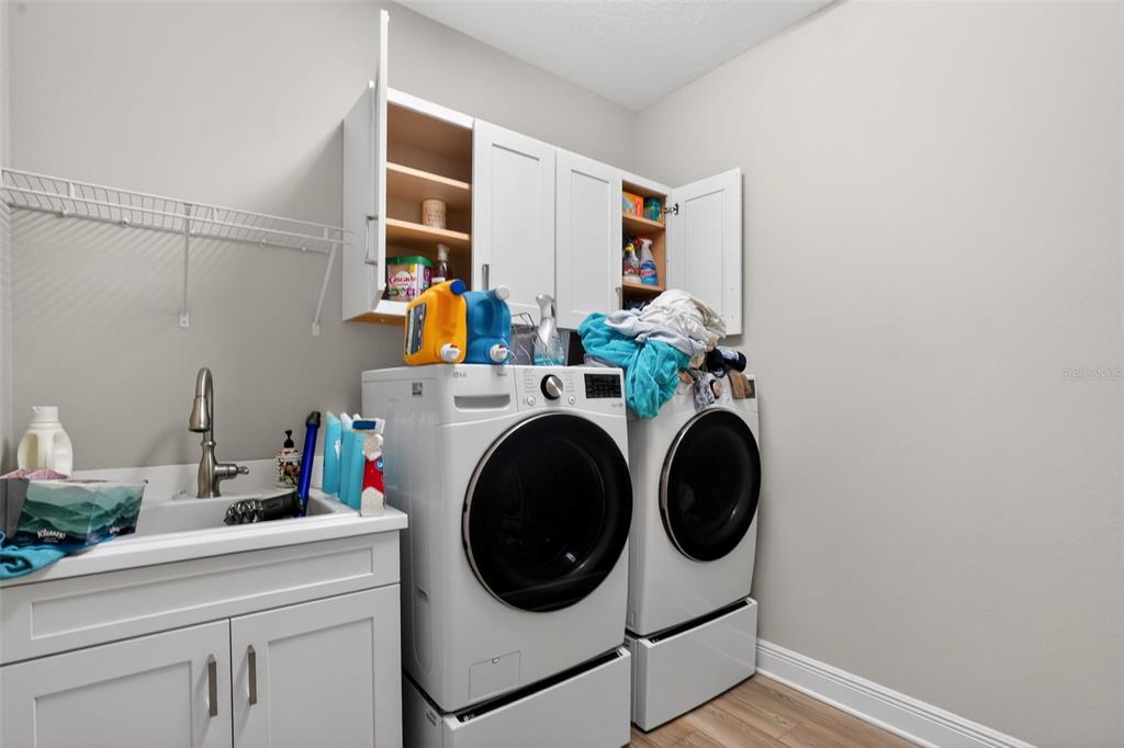 10710 Falling Leaf Court Parrish, FL 34219 - Photo 38 of 50 a utility room with dryer and washer