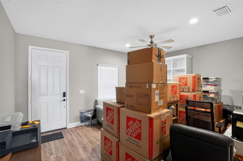 10710 Falling Leaf Court Parrish, FL 34219 - Photo 42 of 50 a living room with furniture and a flat screen tv