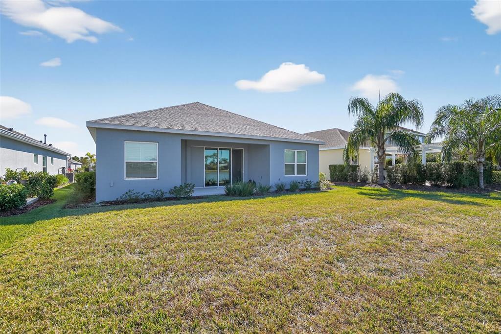 10710 Falling Leaf Court Parrish, FL 34219 - Photo 7 of 50 a front view of house with yard and trees in the background
