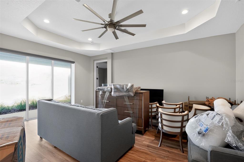 10710 Falling Leaf Court Parrish, FL 34219 - Photo 9 of 50 a living room with furniture and a flat screen tv