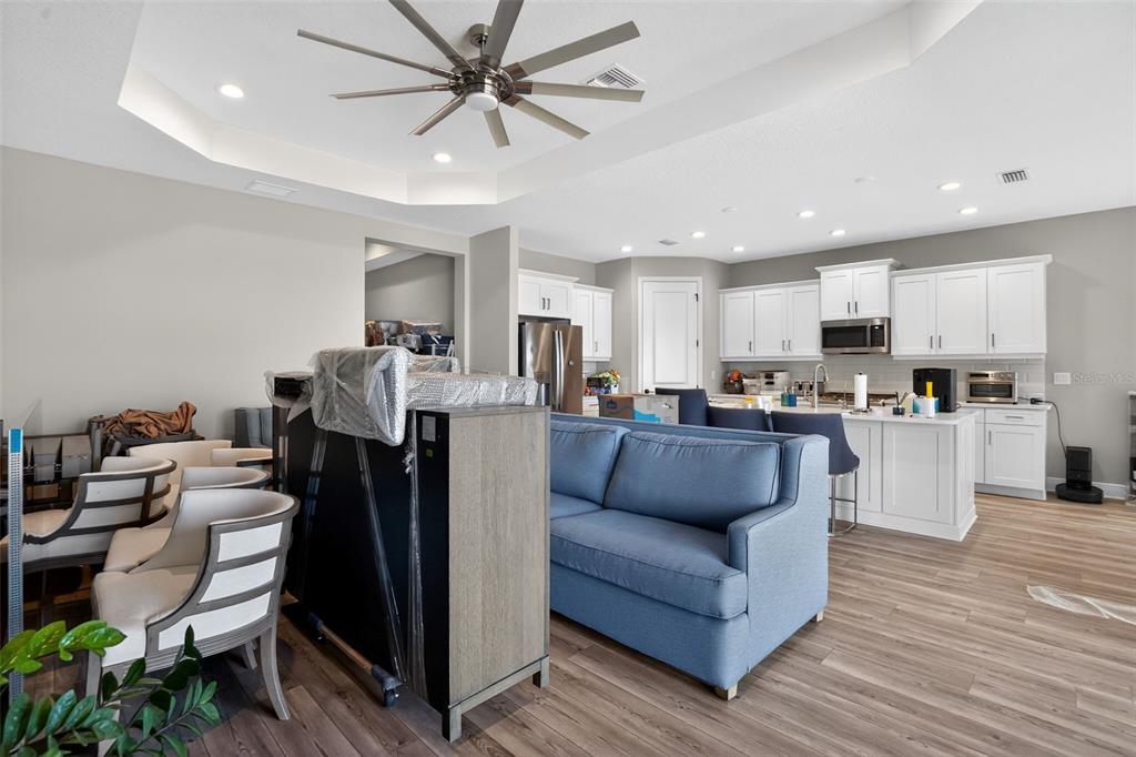 10710 Falling Leaf Court Parrish, FL 34219 - Photo 10 of 50 a living room with furniture and kitchen view