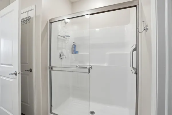 a bathroom with a glass shower door