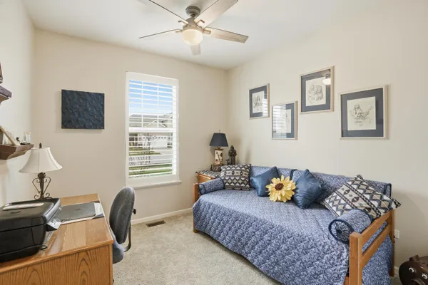 a bedroom with bed and a window