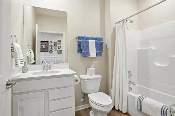 a bathroom with a sink toilet tub and shower