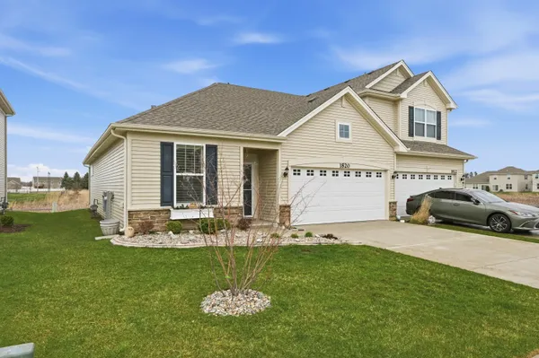 a front view of a house with a garden and plants