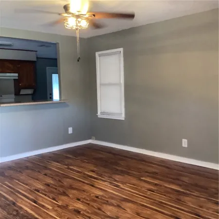 a view of wooden floor and windows in a room