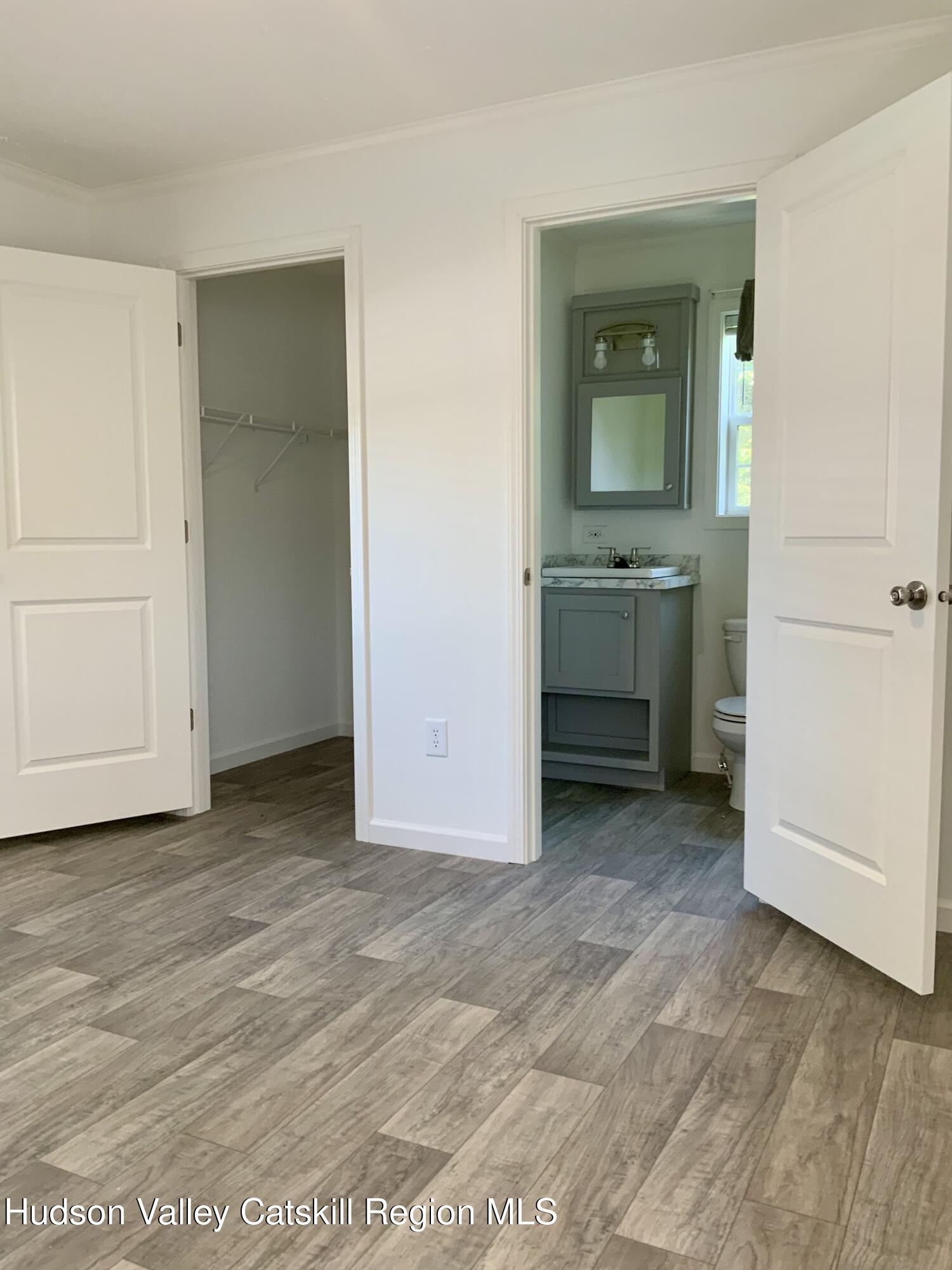 1154 Us-9, Unit 27 Hudson, NY 12534 - Photo 13 of 22 an empty room with a mirror and a sink