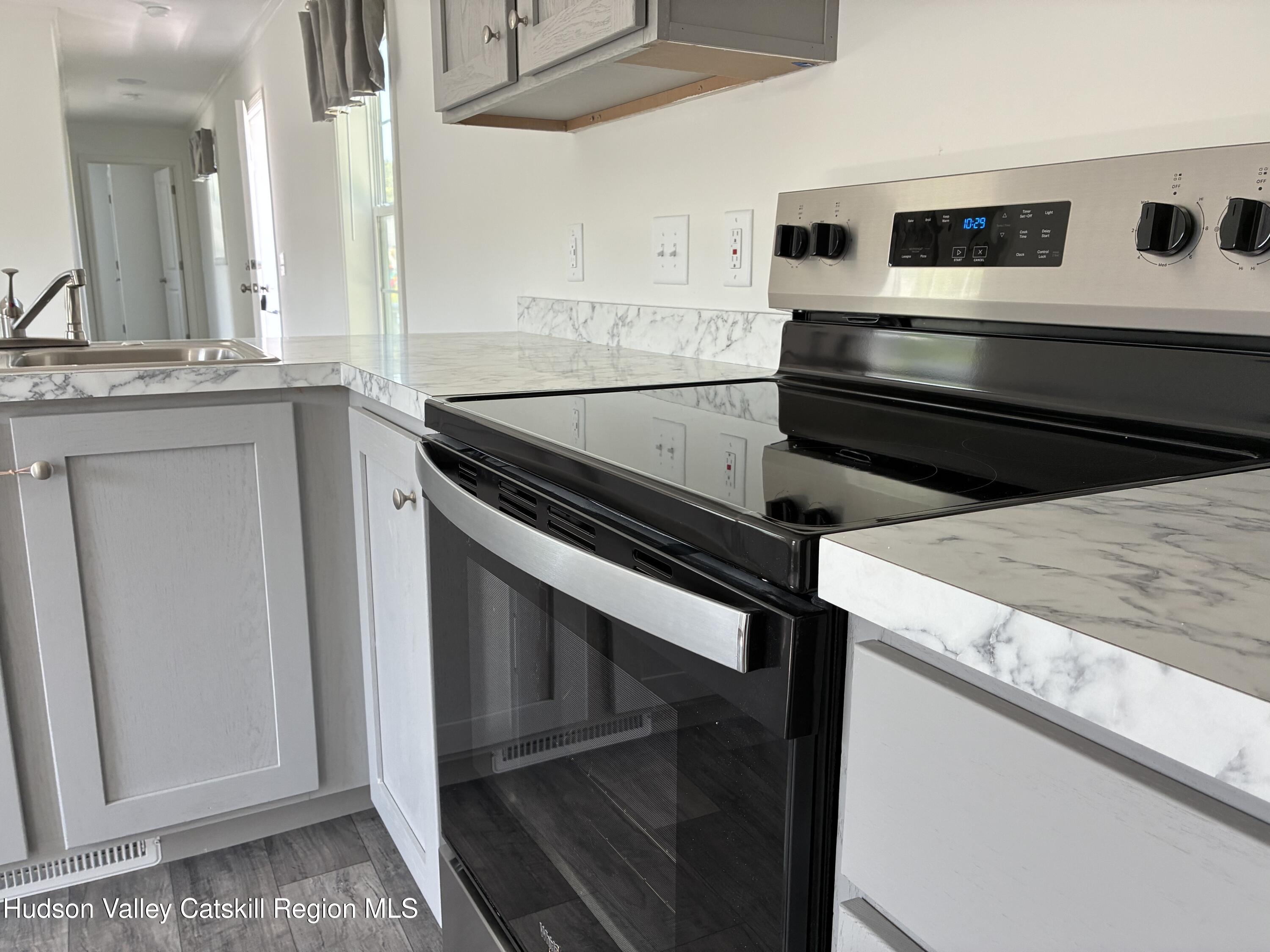 1154 Us-9, Unit 27 Hudson, NY 12534 - Photo 3 of 22 a kitchen with a stove and a microwave