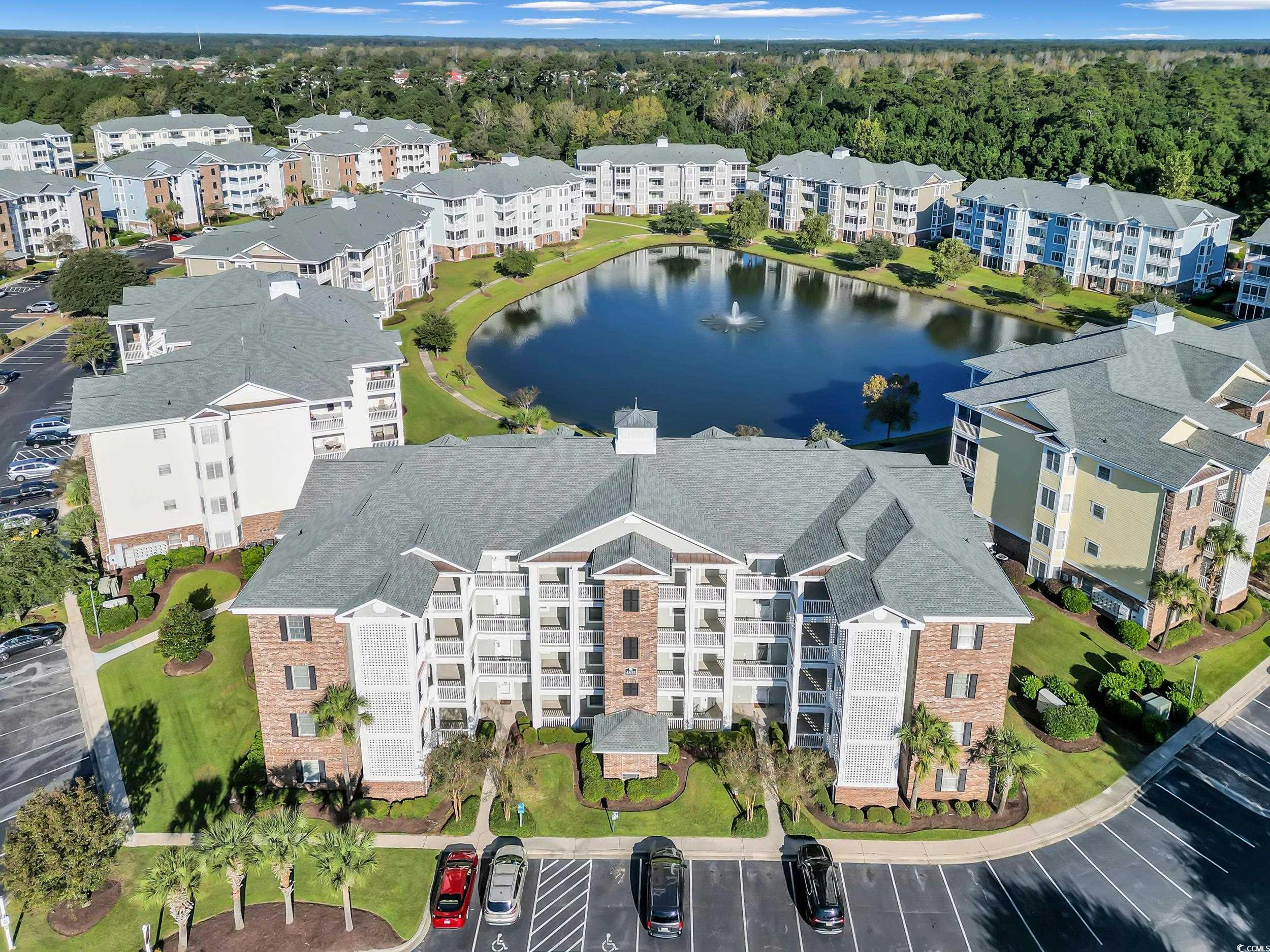 Drone / aerial view of apartment complex / building and a nearby body of water