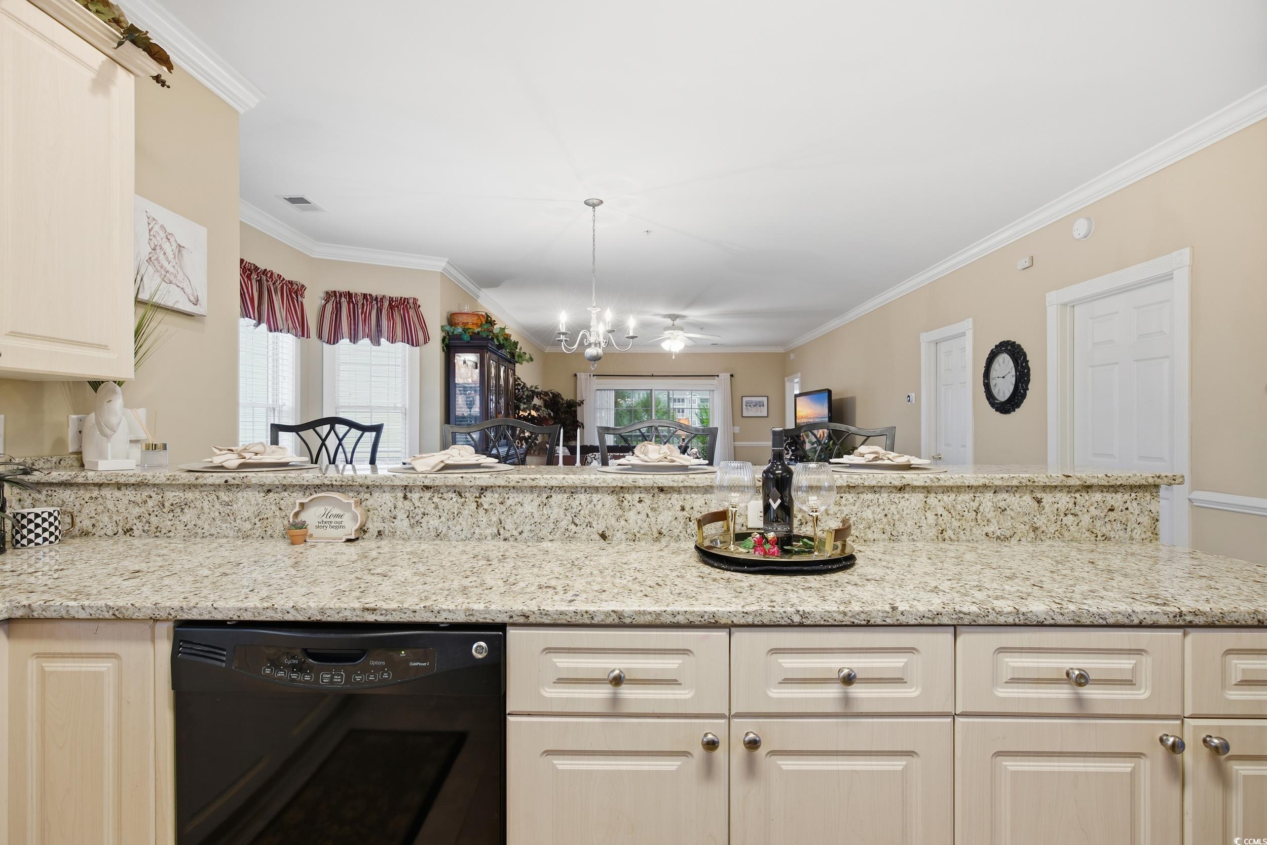 4833 Luster Leaf Circle, Unit 201 Myrtle Beach, SC 29577 - Photo 39 of 39 Kitchen featuring light stone countertops, dishwasher, crown molding, open floor plan, and decorative light fixtures