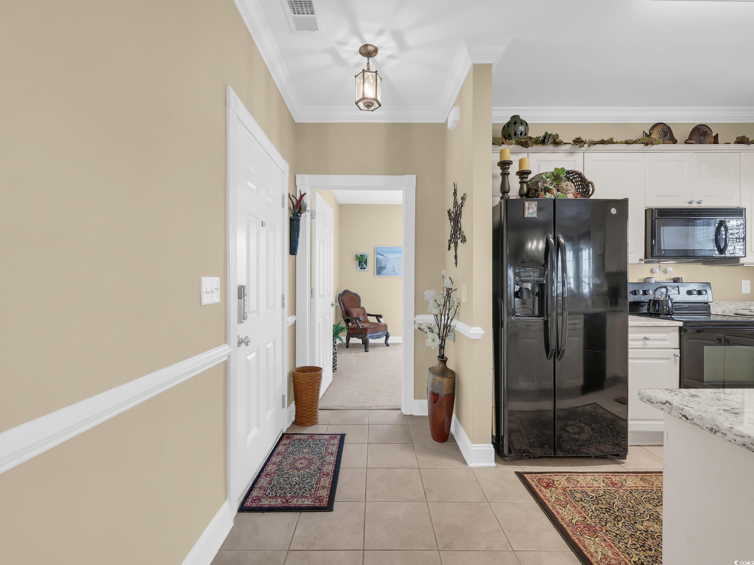 4833 Luster Leaf Circle, Unit 201 Myrtle Beach, SC 29577 - Photo 11 of 39 Hallway featuring light tile patterned flooring and ornamental molding