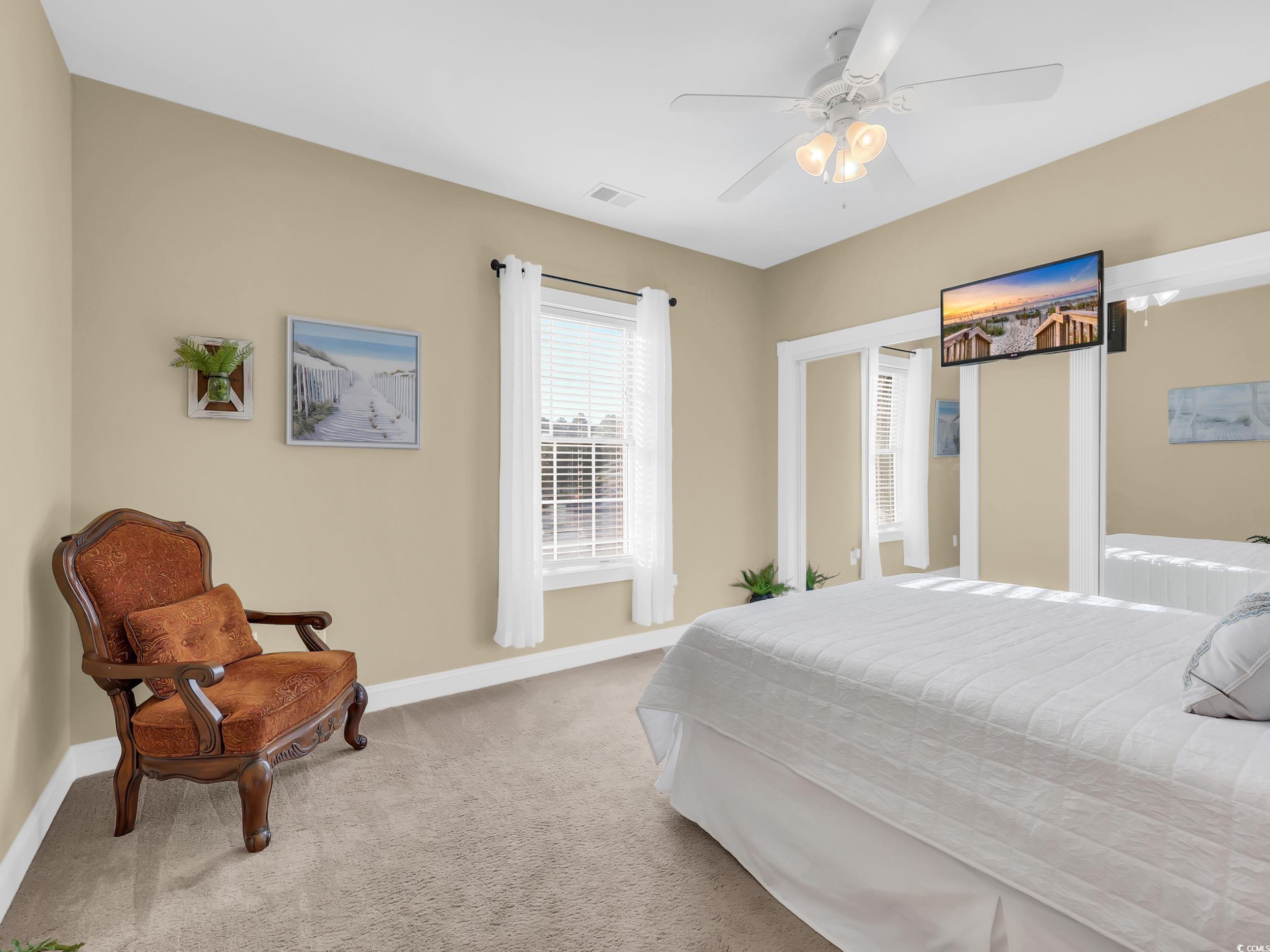 4833 Luster Leaf Circle, Unit 201 Myrtle Beach, SC 29577 - Photo 17 of 39 Carpeted bedroom featuring baseboards and ceiling fan