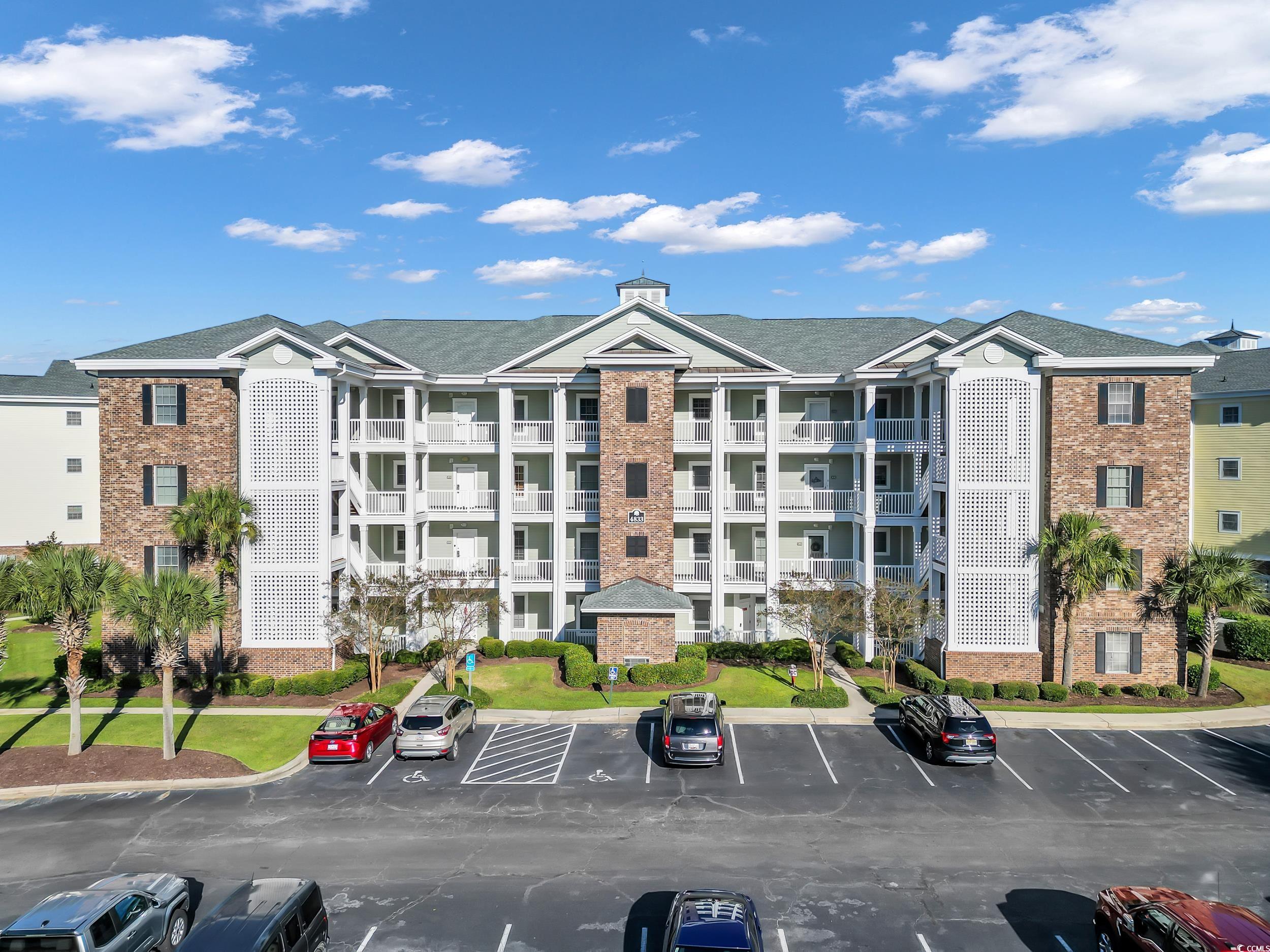 4833 Luster Leaf Circle, Unit 201 Myrtle Beach, SC 29577 - Photo 2 of 39 View of apartment building / complex with uncovered parking