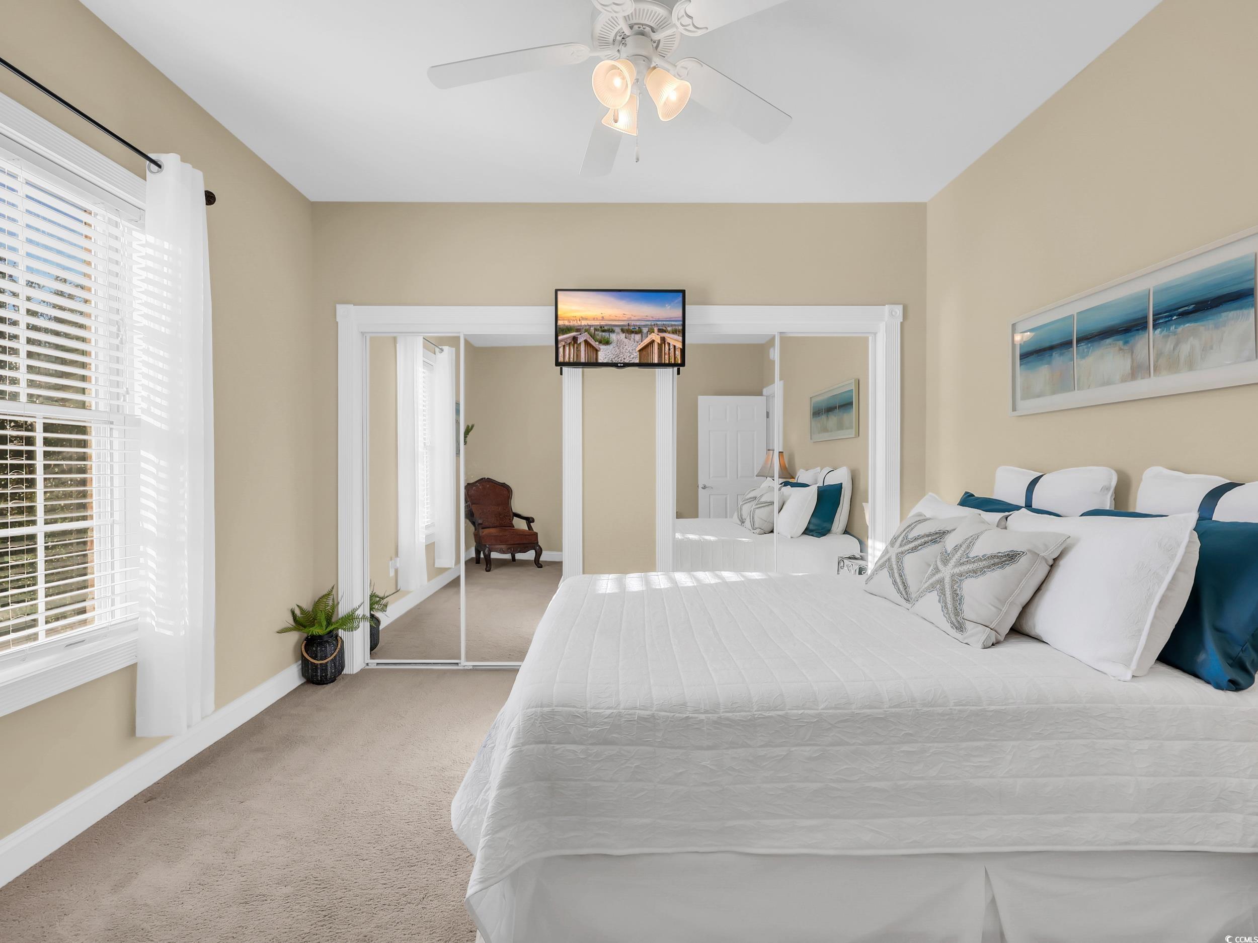 4833 Luster Leaf Circle, Unit 201 Myrtle Beach, SC 29577 - Photo 20 of 39 Carpeted bedroom featuring baseboards and a ceiling fan