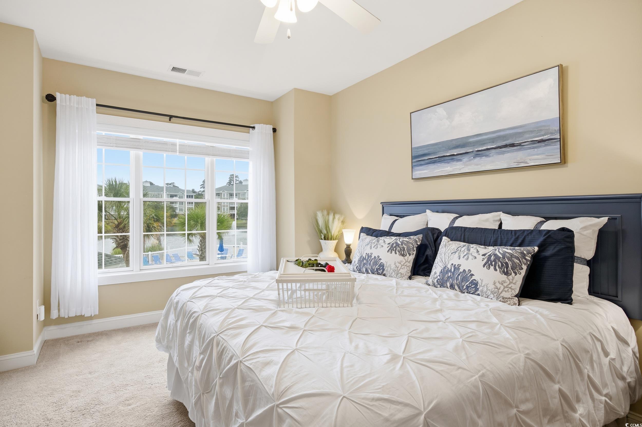 4833 Luster Leaf Circle, Unit 201 Myrtle Beach, SC 29577 - Photo 27 of 39 Carpeted bedroom featuring baseboards and a ceiling fan