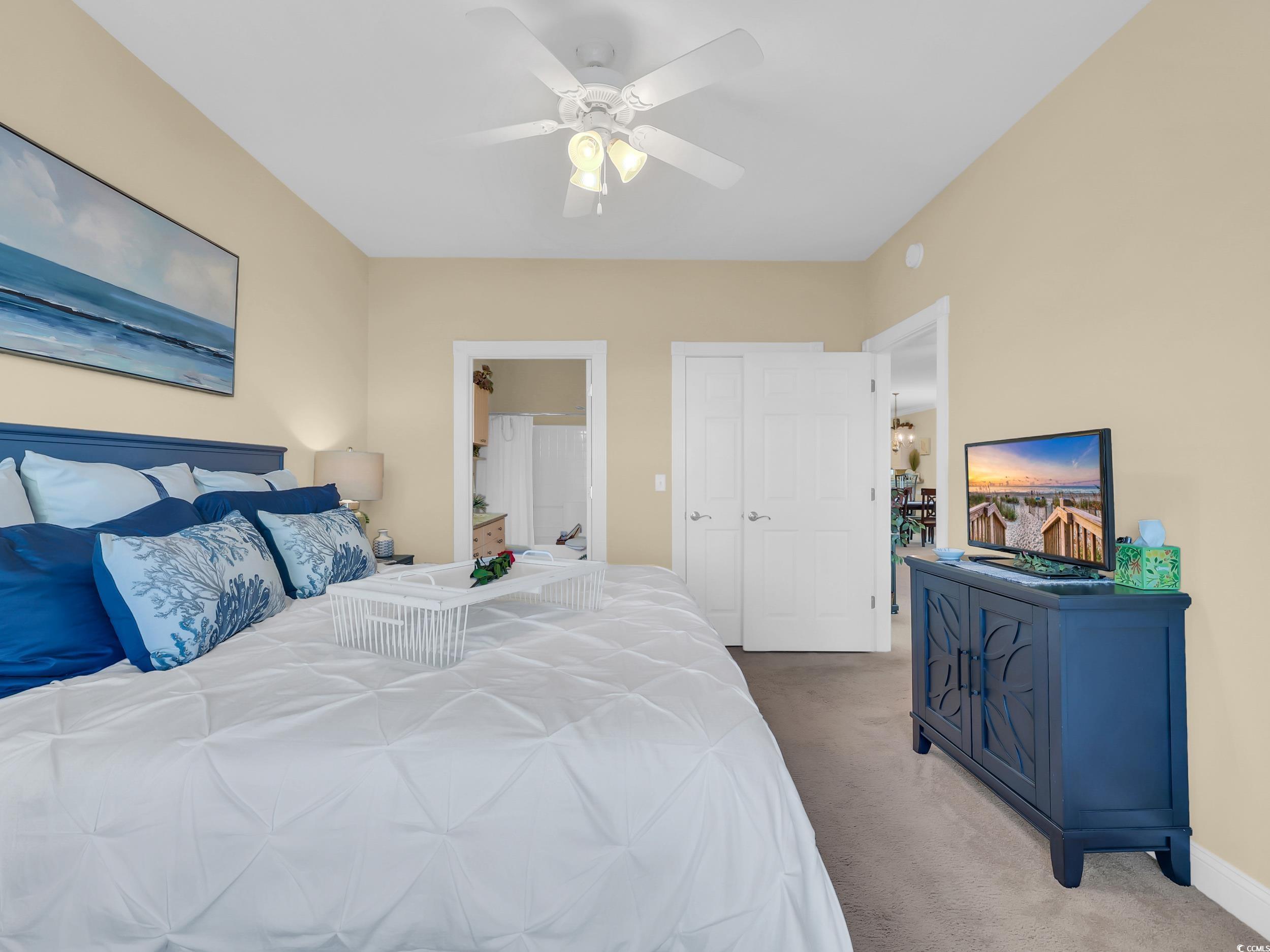 4833 Luster Leaf Circle, Unit 201 Myrtle Beach, SC 29577 - Photo 29 of 39 Carpeted bedroom featuring connected bathroom and a ceiling fan