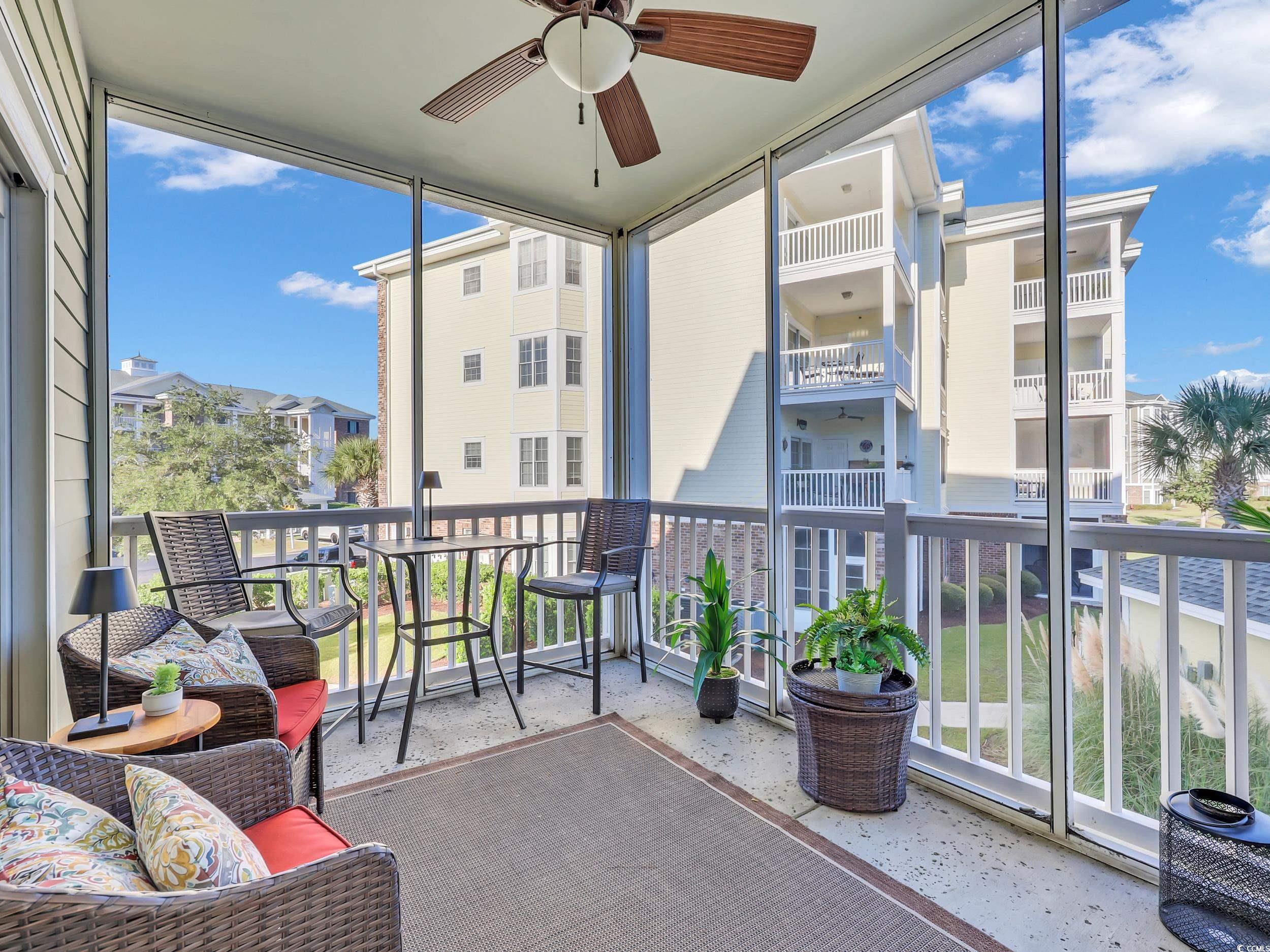 4833 Luster Leaf Circle, Unit 201 Myrtle Beach, SC 29577 - Photo 33 of 39 Balcony with a ceiling fan and a sunroom