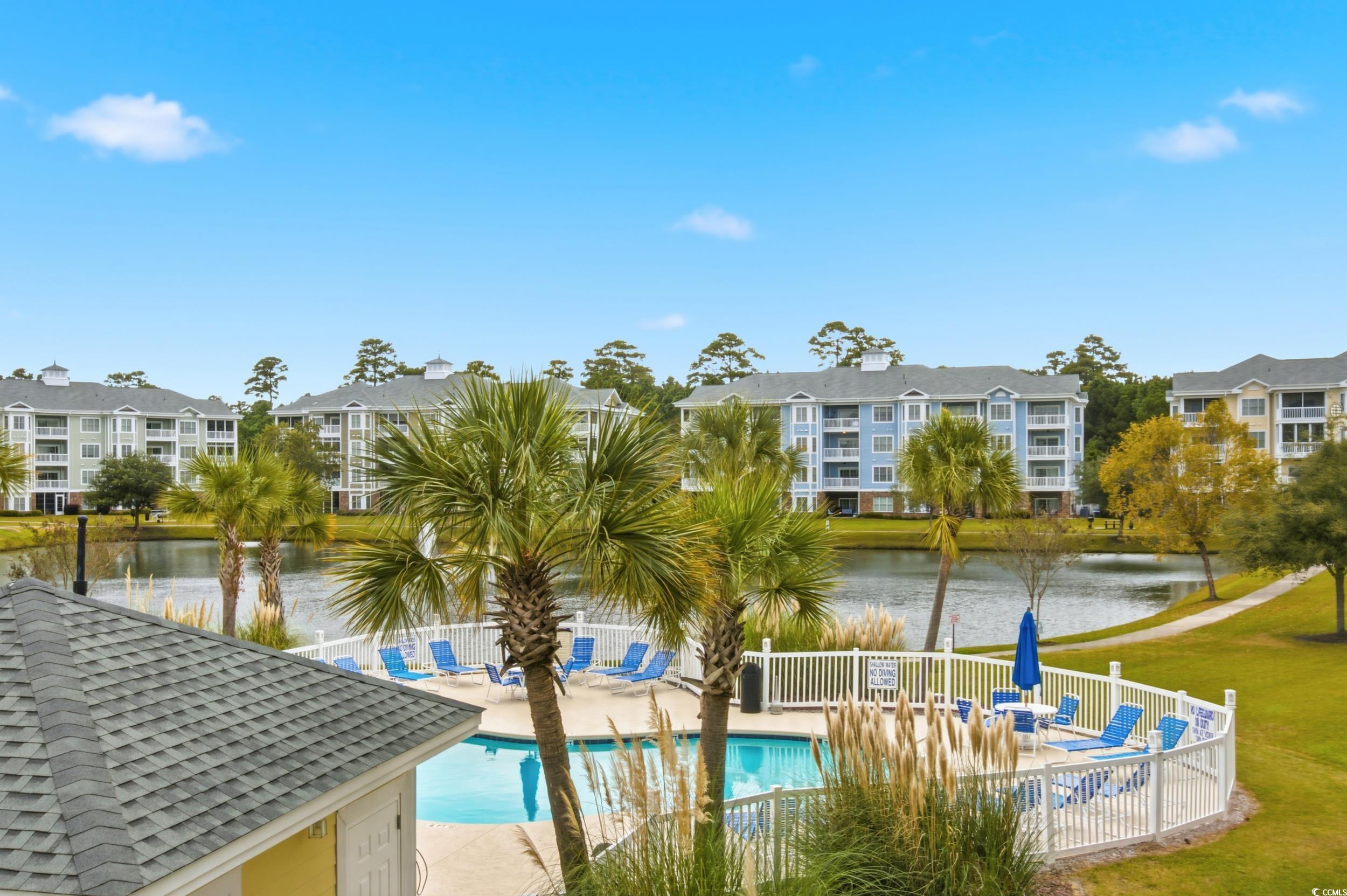 4833 Luster Leaf Circle, Unit 201 Myrtle Beach, SC 29577 - Photo 34 of 39 Community pool with a water view and a patio