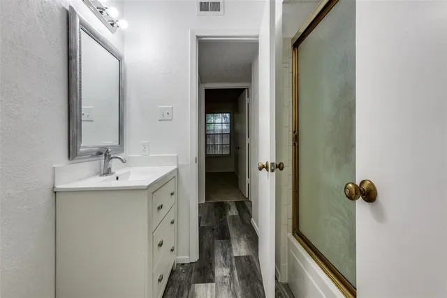 a bathroom with a sink and mirror