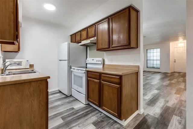 a kitchen with stainless steel appliances granite countertop a sink stove and microwave