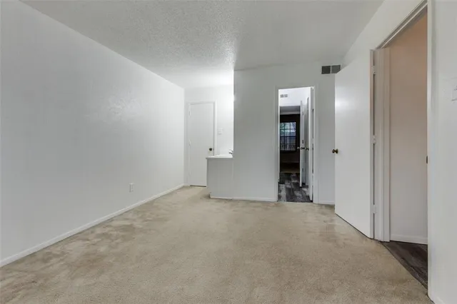 an empty room with closet and wooden door