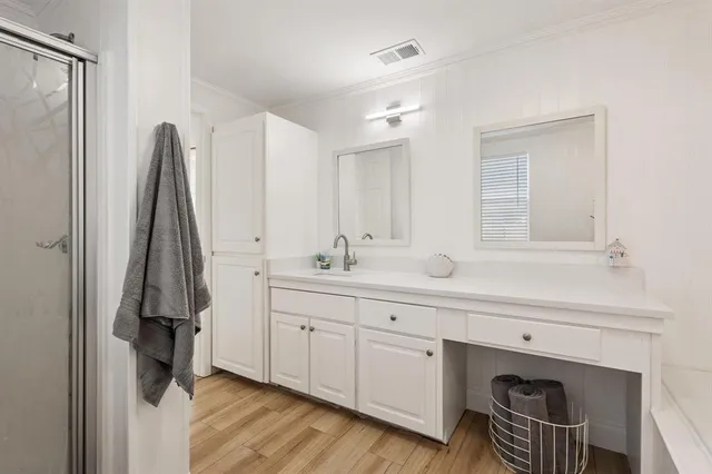 an aerial view of a house with a garden and lake view