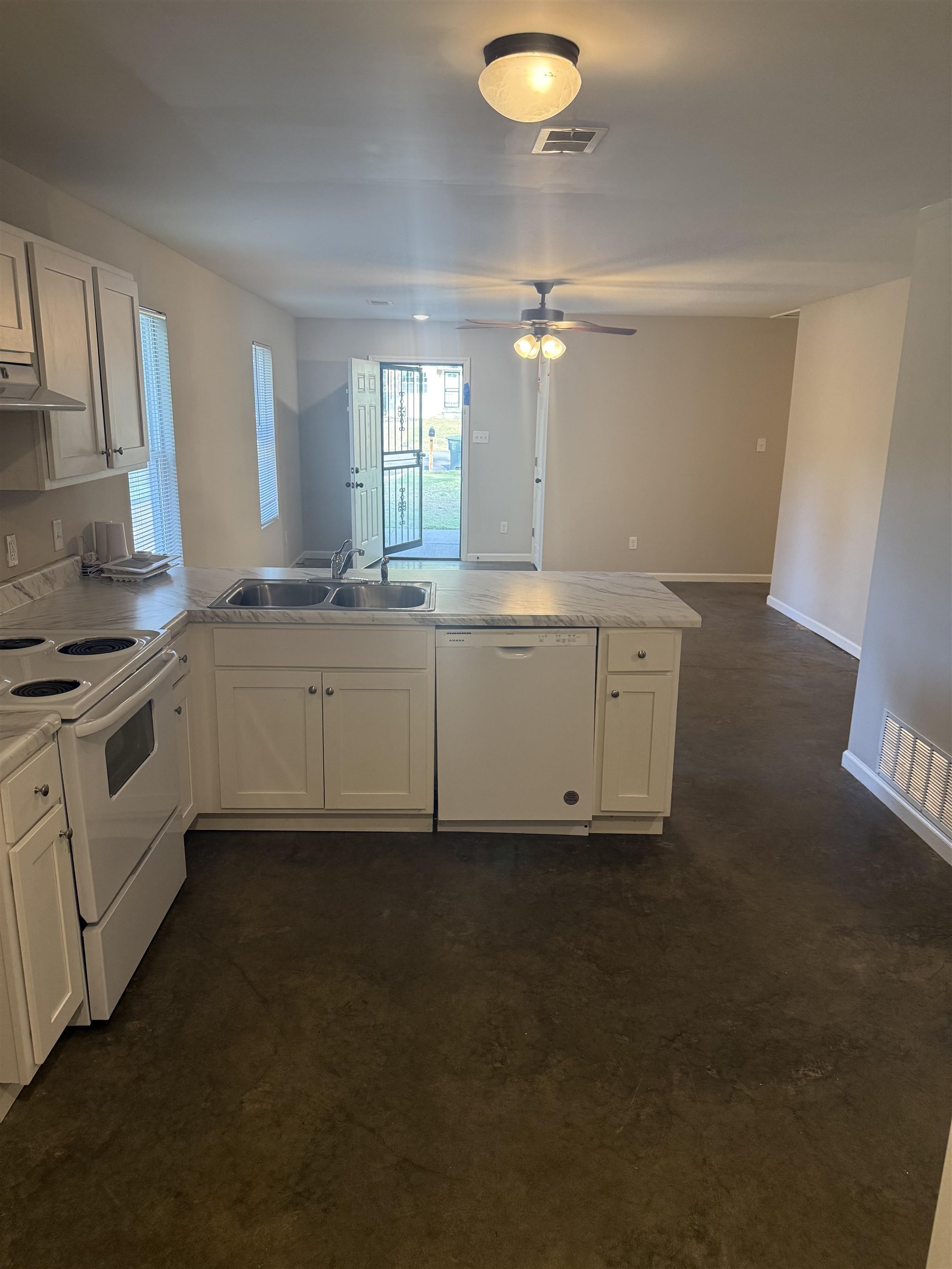 4589 Range Line Road Memphis, TN 38127 - Photo 25 of 25 Kitchen featuring white appliances, a peninsula, light countertops, open floor plan, and ventilation hood