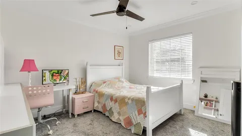 a bed room with a bed and a chair