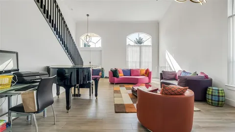 a living room with fireplace furniture and a chandelier