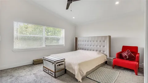 a bedroom with a bed and a couch