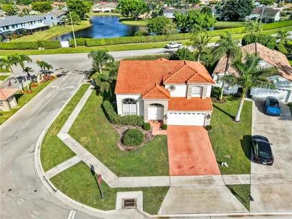an aerial view of a house with a yard and lake view