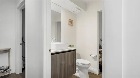a bathroom with a toilet a sink and a mirror