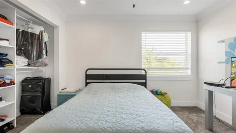 a bedroom with a bed and a tv