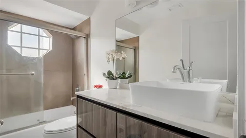 a bathroom with a sink a toilet and tub