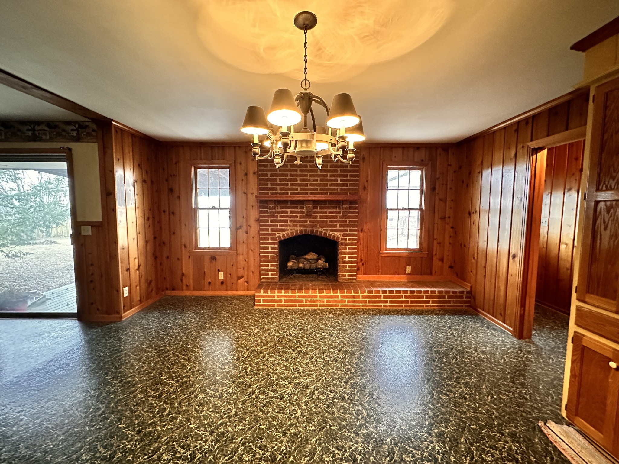 2180 South Williams Road Greenbrier, TN 37073 - Photo 4 of 19 a view of a livingroom with a fireplace wooden floor and chandelier