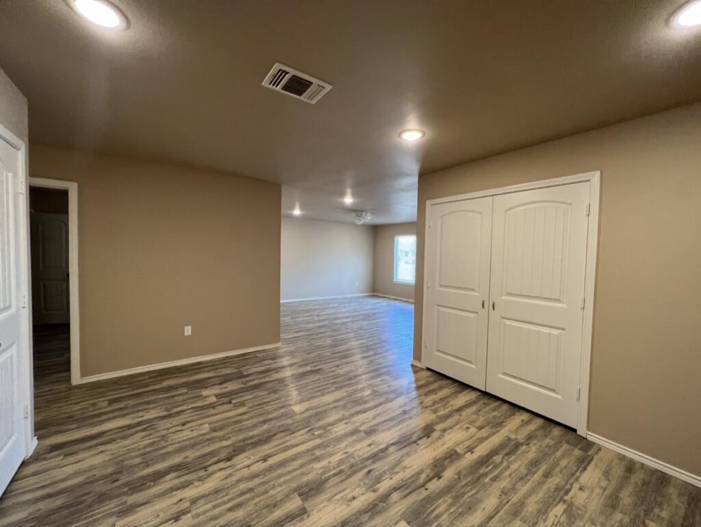 7401 5th Street, Unit 1 Lubbock, TX 79416 - Photo 14 of 19 a view of hallway with wooden floor