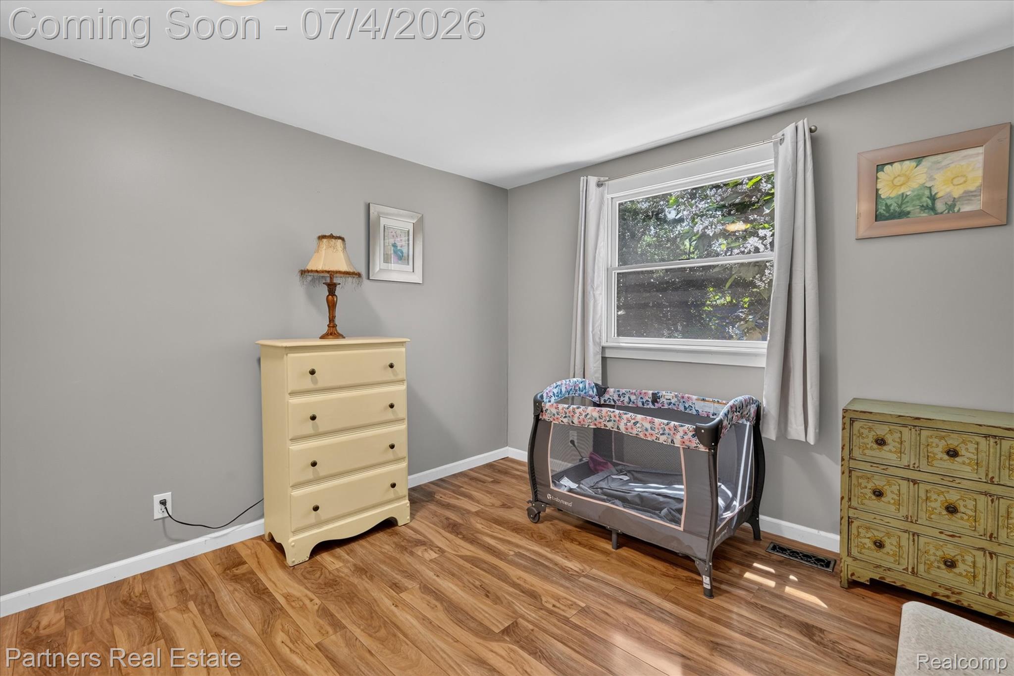 2500 Hubert Road Brighton, MI 48114 - Photo 32 of 53 Room featuring wood-finish flooring, light grey painted walls, and white trim