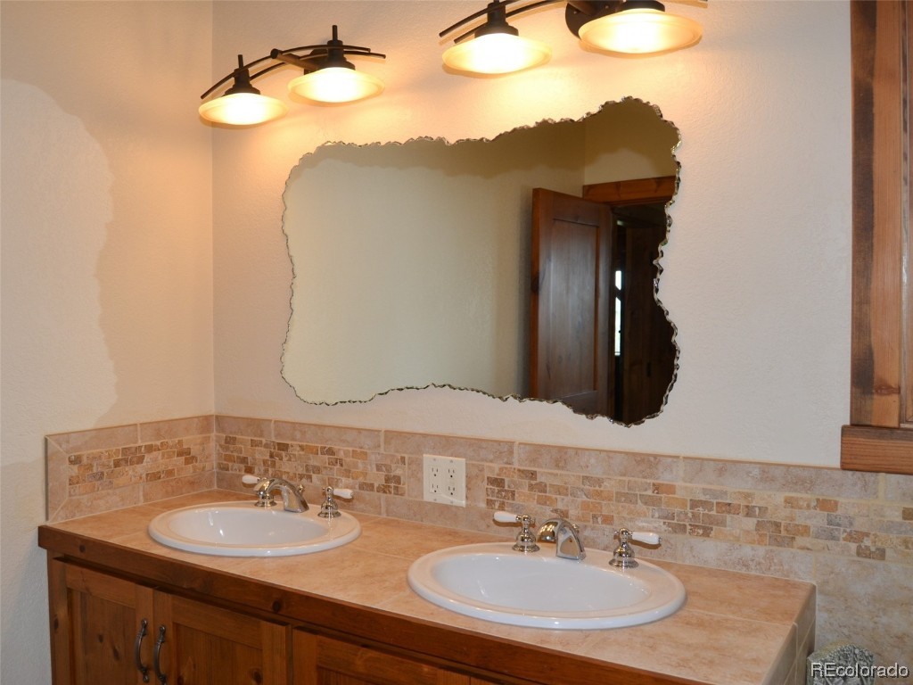 376 Deer Crossing Road Tie Siding, WY 82084 - Photo 7 of 28 a bathroom with a sink and a mirror