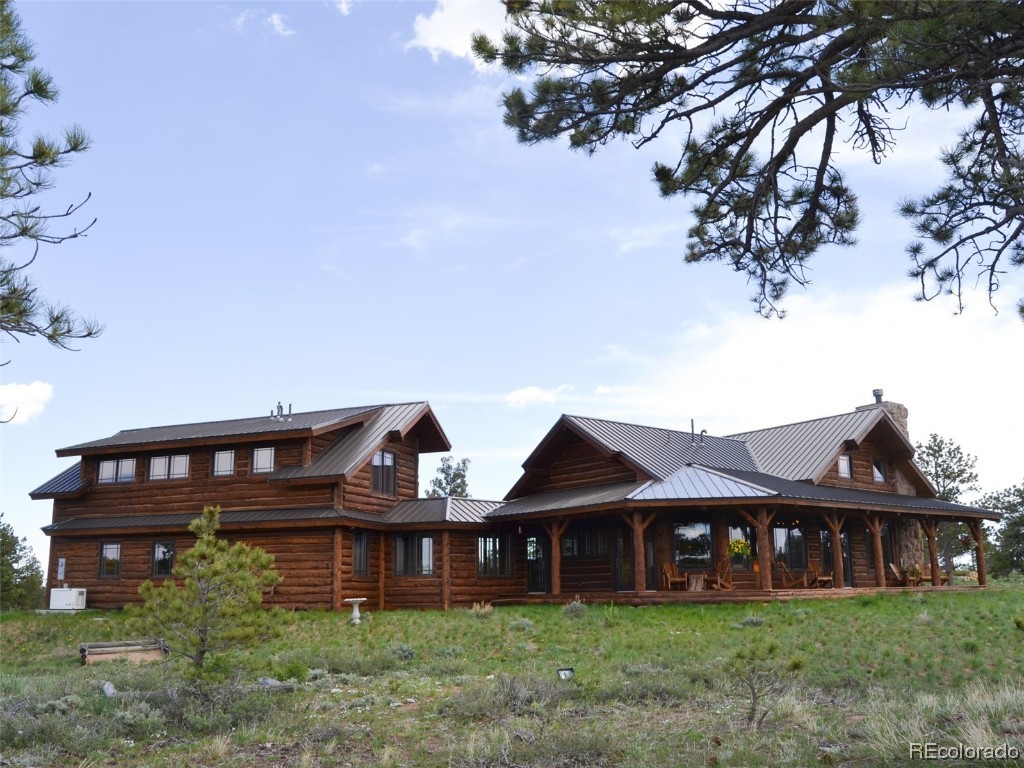 376 Deer Crossing Road Tie Siding, WY 82084 - Photo 9 of 28 a front view of a house with garden