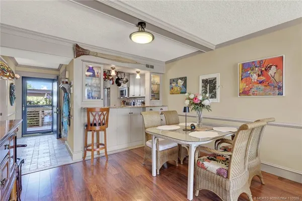 a very nice looking living room with a large window and wooden floor