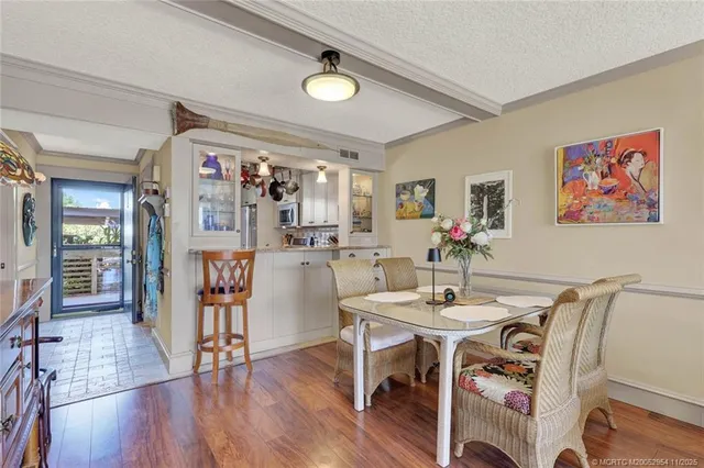 a very nice looking living room with a large window and wooden floor