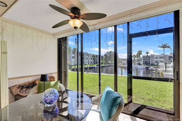 a living room with furniture and a floor to ceiling window