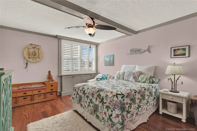 a bedroom with a large bed couch and a window