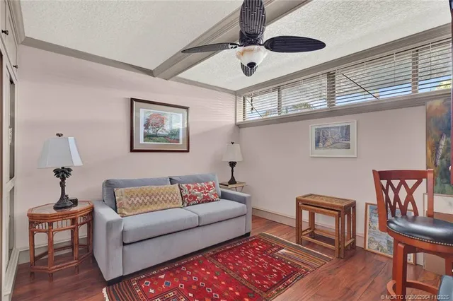 a view of kitchen with stainless steel appliances granite countertop cabinets and wooden floor